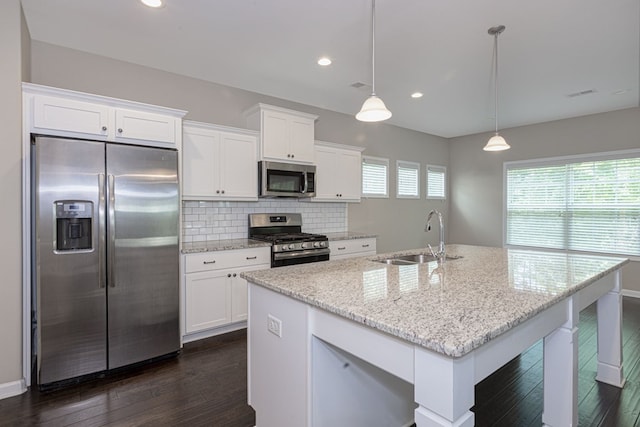 kitchen with a sink, tasteful backsplash, appliances with stainless steel finishes, and white cabinets