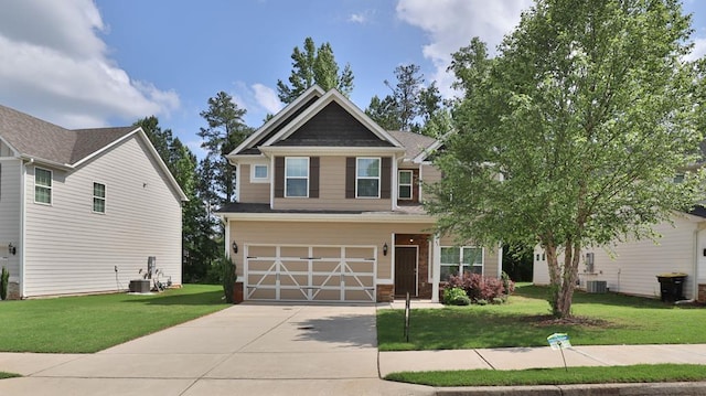 craftsman house with central AC, concrete driveway, and a front yard