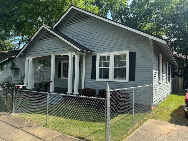 bungalow-style house with fence private yard, a front yard, and covered porch