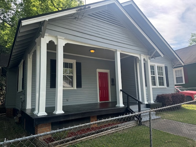 view of front of house featuring a porch and fence private yard