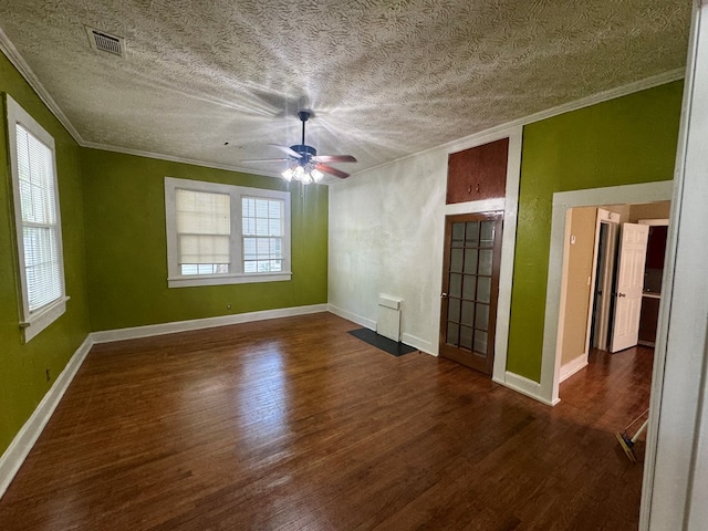 unfurnished bedroom with visible vents, baseboards, wood finished floors, ceiling fan, and crown molding