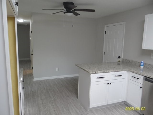 1520 Barcelona Dr, Columbus, GA 31907 - kitchen featuring dishwasher, a ceiling fan, a peninsula, light wood-type flooring, and white cabinets
