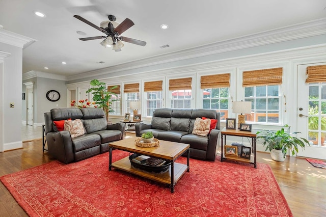 living room with ceiling fan, wood-type flooring, and ornamental molding