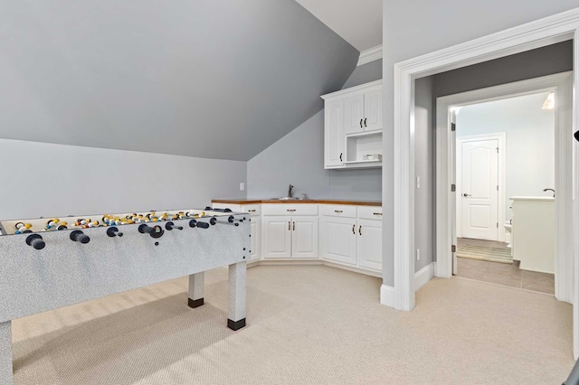 game room featuring light carpet, vaulted ceiling, and sink