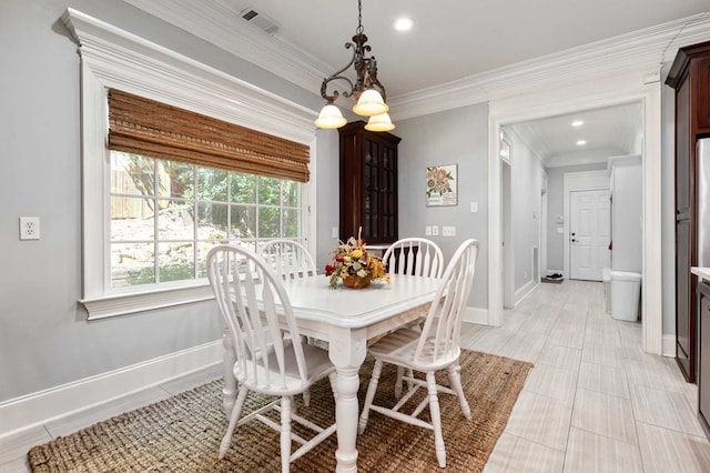 dining area with a notable chandelier and ornamental molding