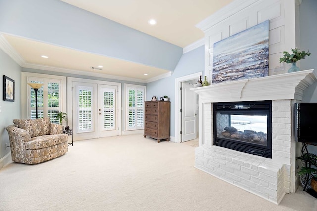 living room with crown molding, a fireplace, light colored carpet, and french doors