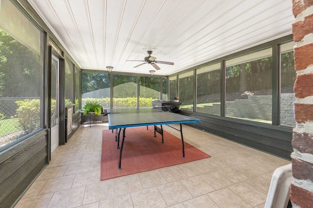 sunroom featuring ceiling fan and wood ceiling