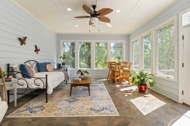 sunroom featuring ceiling fan