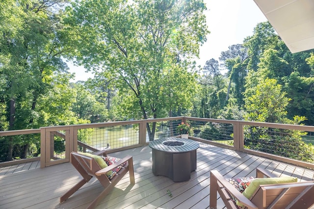 wooden terrace featuring an outdoor fire pit