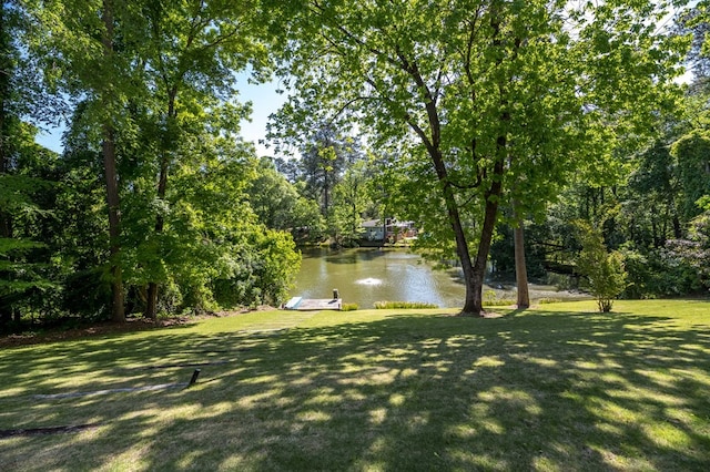 view of yard featuring a boat dock and a water view