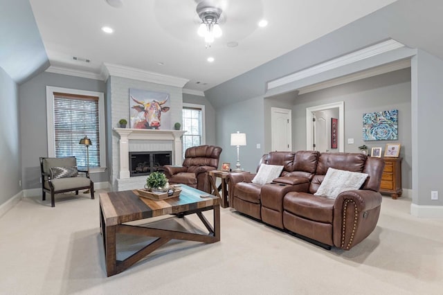 living room with light carpet, ornamental molding, ceiling fan, a fireplace, and lofted ceiling