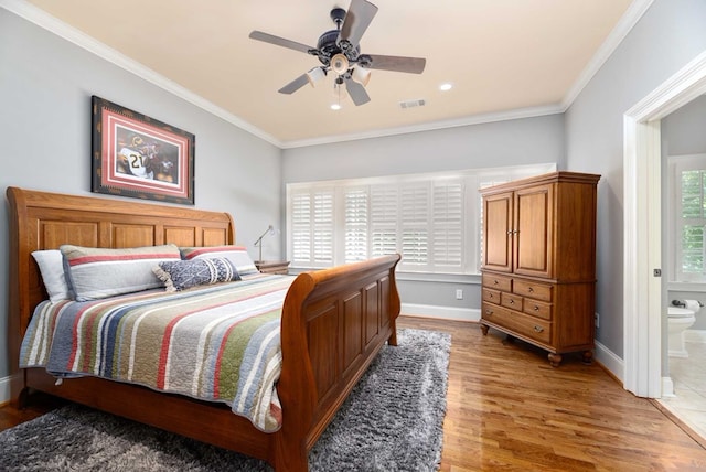 bedroom with connected bathroom, hardwood / wood-style flooring, ceiling fan, and ornamental molding