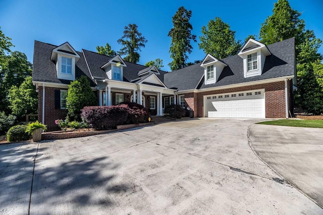 cape cod-style house featuring a garage