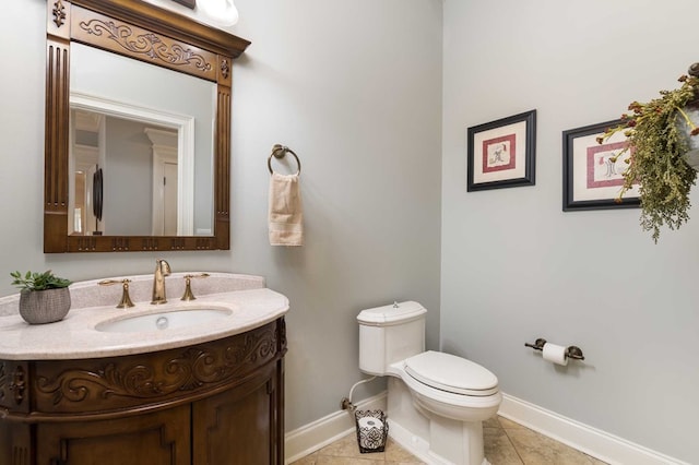 bathroom featuring tile patterned flooring, vanity, and toilet