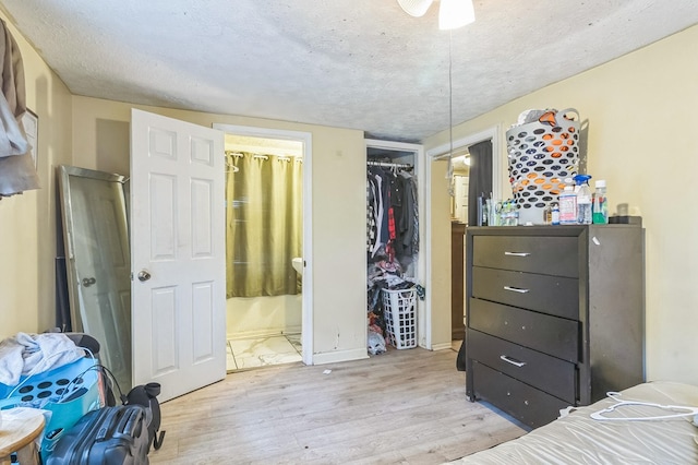 2871 Barbara Rd, Columbus, GA 31907 - bedroom featuring light wood finished floors, a closet, ensuite bath, and a textured ceiling