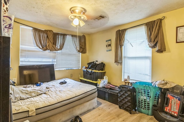 2871 Barbara Rd, Columbus, GA 31907 - bedroom with wood finished floors, multiple windows, and a textured ceiling