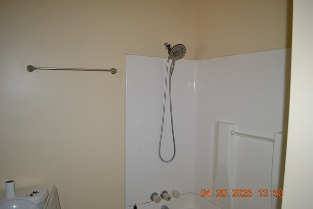 bathroom with toilet and shower / bath combination