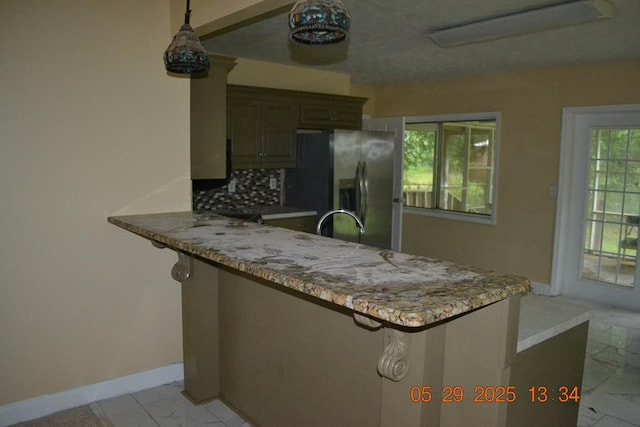 3836 Mulberry Dr, Columbus, GA 31907 - kitchen with stainless steel fridge with ice dispenser, light marble finish flooring, baseboards, and a peninsula
