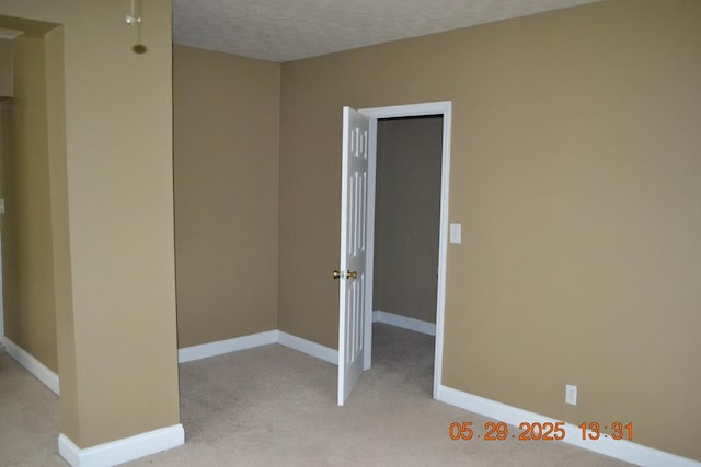 3836 Mulberry Dr, Columbus, GA 31907 - empty room with baseboards, light colored carpet, and a textured ceiling