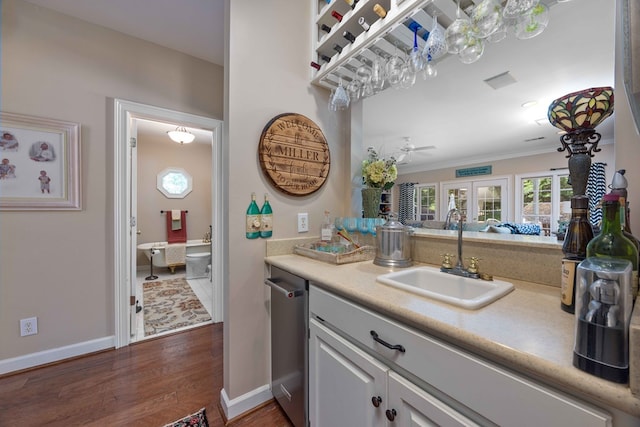 12225 County Line Rd, Midland, GA 31820 - bar area featuring a sink, dark wood finished floors, baseboards, ornamental molding, and stainless steel dishwasher