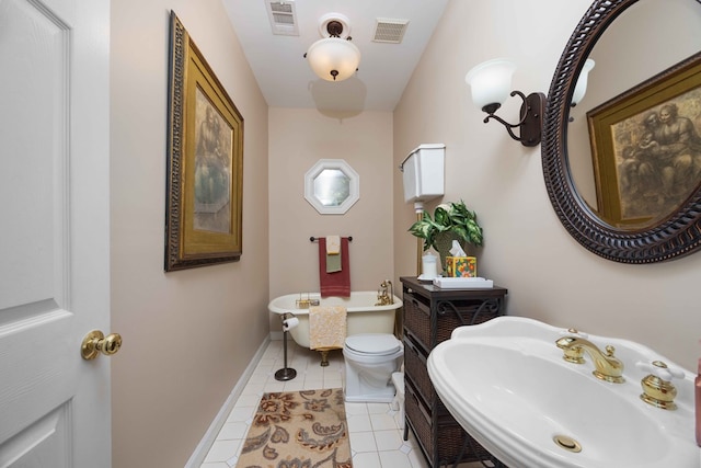 12225 County Line Rd, Midland, GA 31820 - full bathroom featuring a sink, a freestanding tub, tile patterned flooring, baseboards, and toilet
