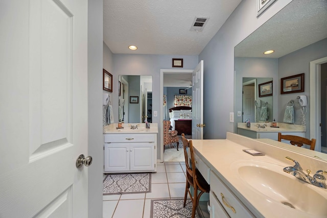 12225 County Line Rd, Midland, GA 31820 - full bathroom featuring tile patterned flooring, two vanities, ensuite bathroom, and a textured ceiling