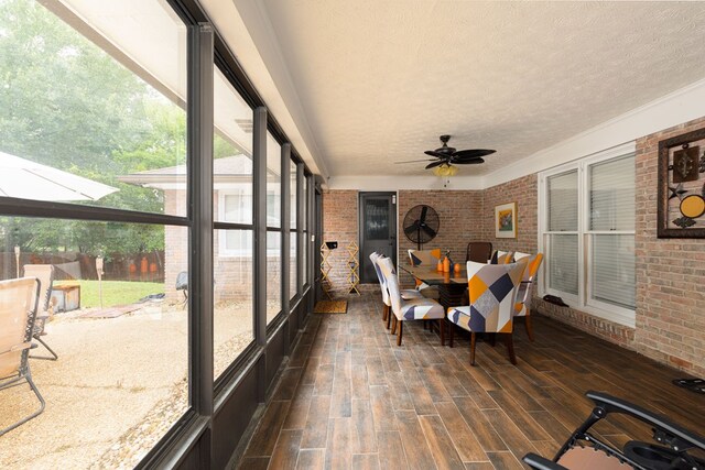 4524 Hedingham Ln, Columbus, GA 31907 - sunroom featuring brick wall, a textured ceiling, a ceiling fan, wood finished floors, and healthy amount of natural light