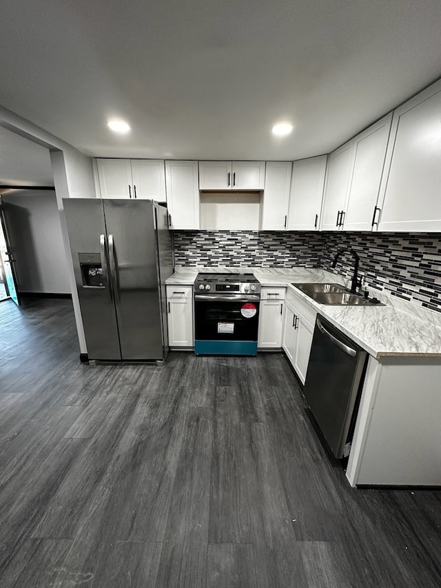 kitchen featuring decorative backsplash, dark hardwood / wood-style flooring, stainless steel appliances, sink, and white cabinets