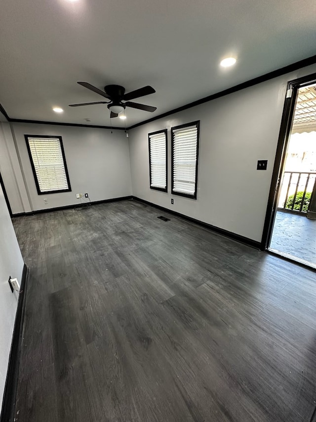 unfurnished room featuring dark hardwood / wood-style floors, ceiling fan, and ornamental molding