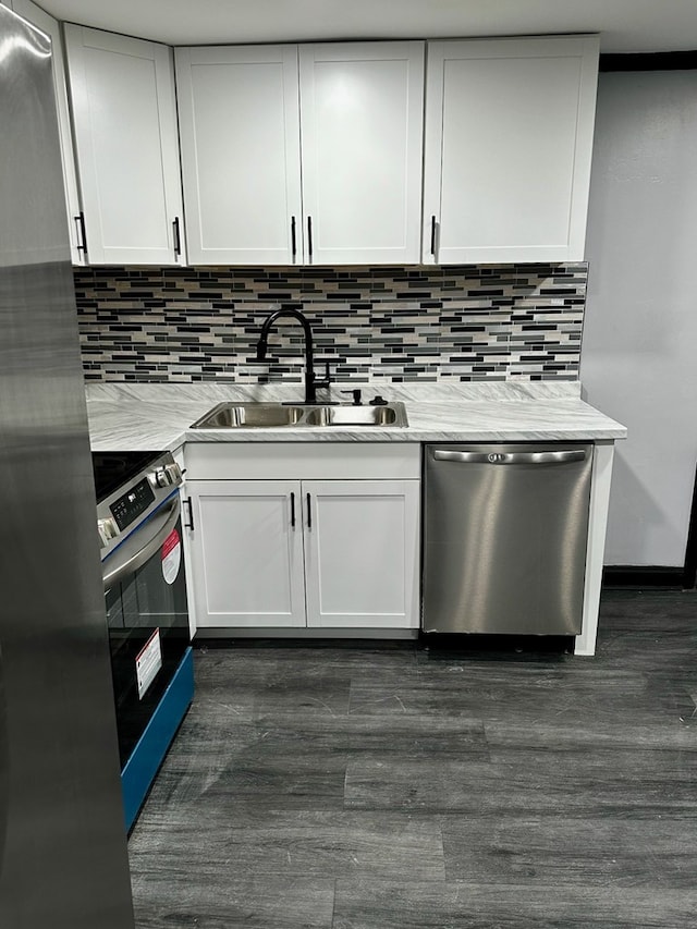 kitchen featuring white cabinets, sink, light stone countertops, and stainless steel appliances