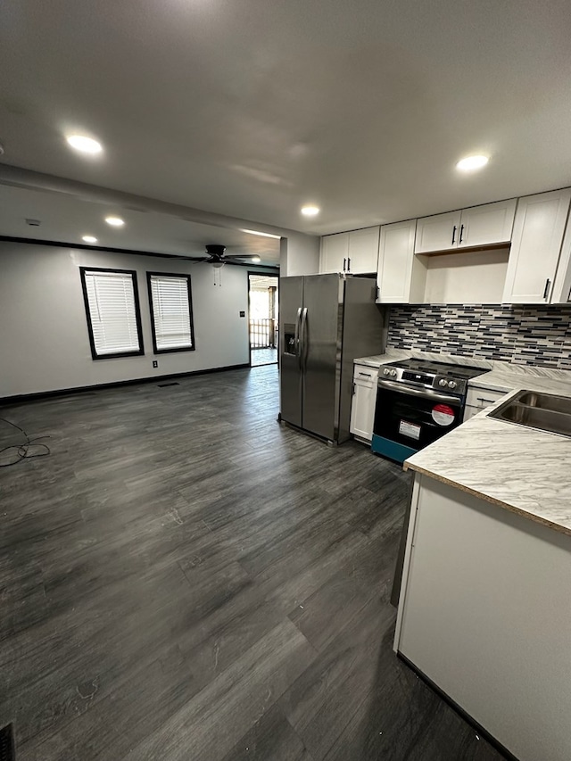 kitchen with white cabinetry, dark hardwood / wood-style flooring, and appliances with stainless steel finishes