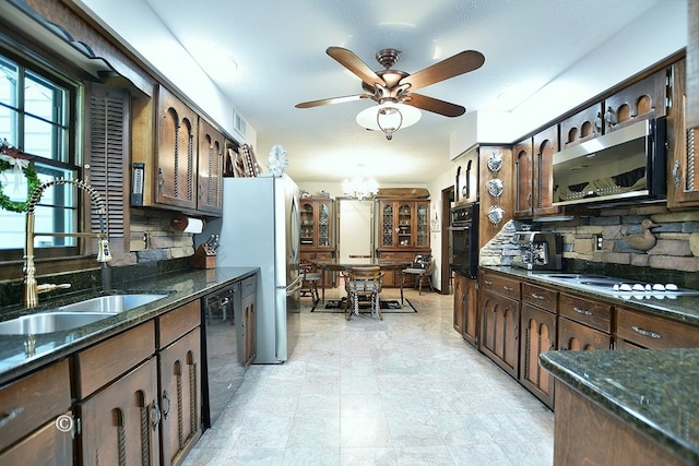 1237 Smith Rd, Fortson, GA 31808 - kitchen with a sink, black appliances, ceiling fan, dark brown cabinetry, and dark stone countertops