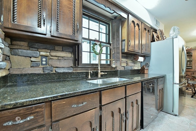 1237 Smith Rd, Fortson, GA 31808 - kitchen featuring a sink, black dishwasher, dark stone countertops, dark brown cabinets, and freestanding refrigerator