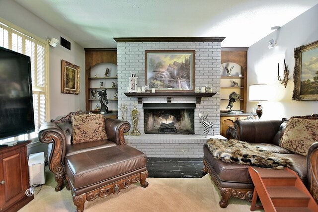 living area with built in features, carpet, a textured ceiling, and a brick fireplace