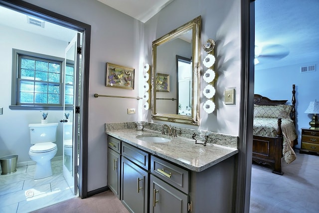 1237 Smith Rd, Fortson, GA 31808 - bathroom featuring toilet, vanity, ensuite bathroom, and baseboards