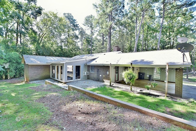 1237 Smith Rd, Fortson, GA 31808 - rear view of property featuring a chimney, brick siding, view of wooded area, and a yard