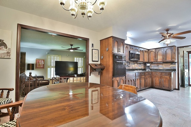 1237 Smith Rd, Fortson, GA 31808 - dining room with a ceiling fan, a chandelier, and a textured ceiling
