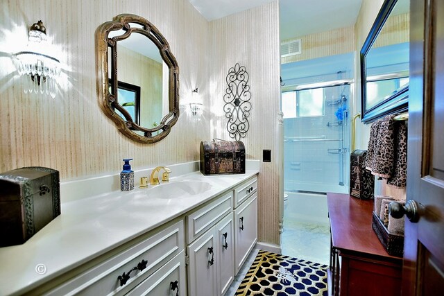 1237 Smith Rd, Fortson, GA 31808 - bathroom featuring wallpapered walls, vanity, toilet, and bath / shower combo with glass door