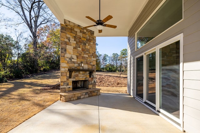 view of patio featuring ceiling fan and an outdoor stone fireplace