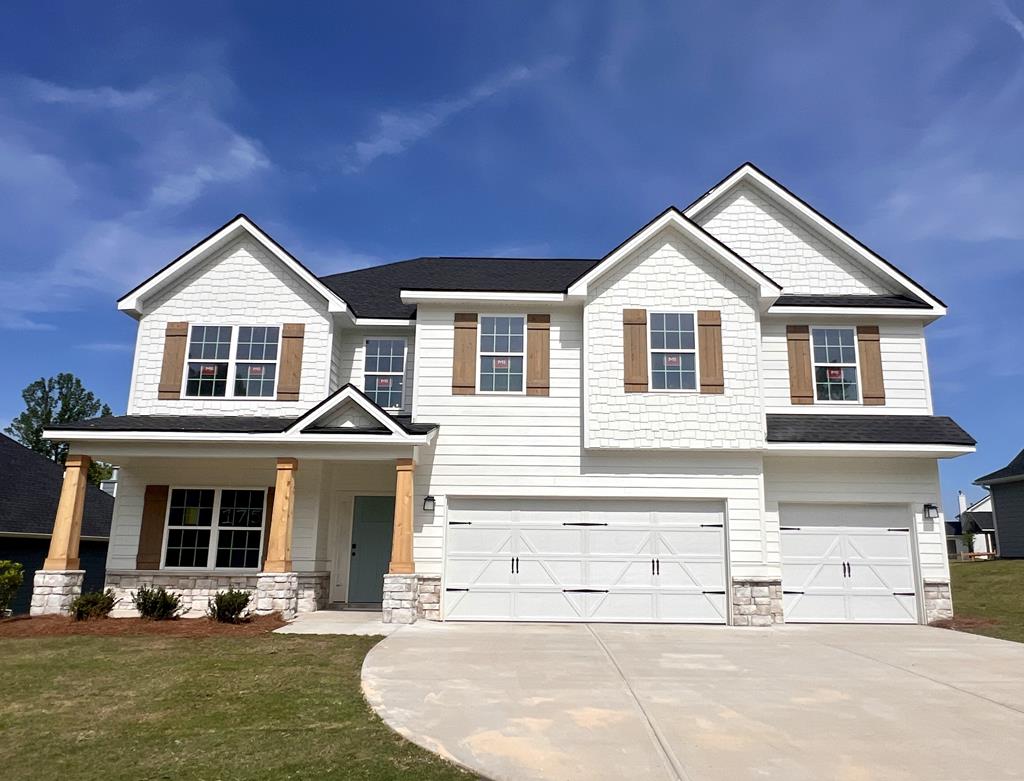 4043 Holstein Hl, Columbus, GA 31904 - view of front of house featuring driveway, stucco siding, and a garage