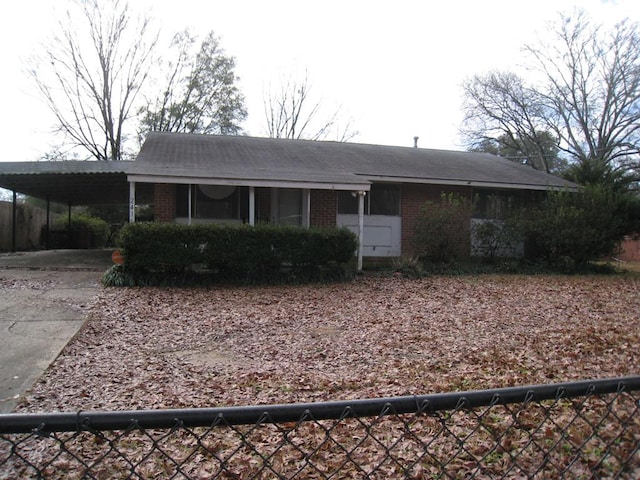 ranch-style house featuring a carport