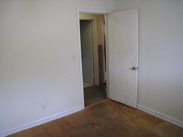 empty room with dark parquet floors