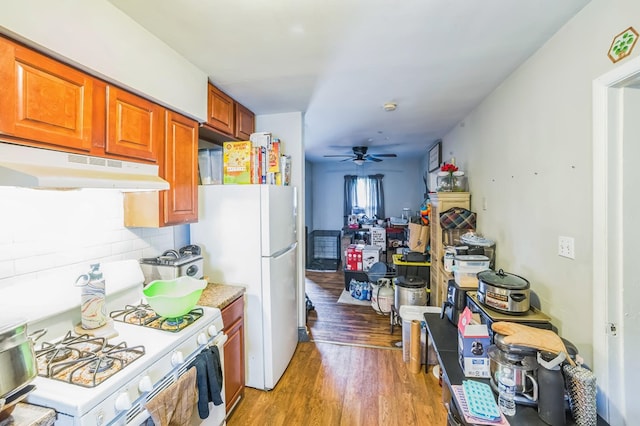 4512 Lunsford St, Columbus, GA 31903 - kitchen with under cabinet range hood, white appliances, light wood-type flooring, decorative backsplash, and ceiling fan
