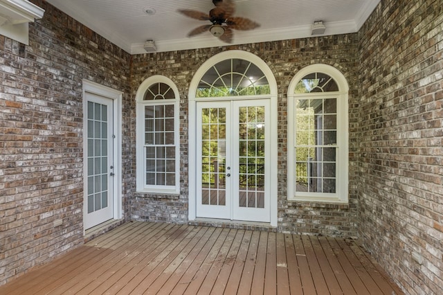 exterior space featuring brick siding, a ceiling fan, a wooden deck, and french doors