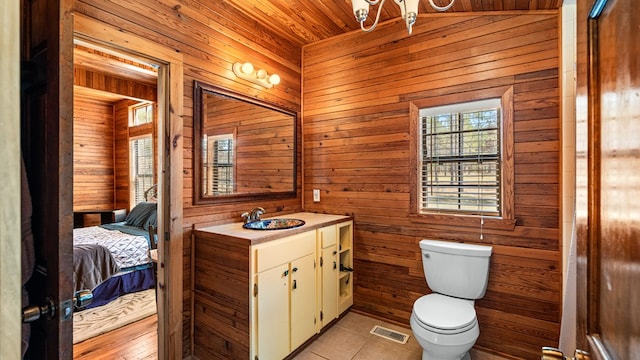 125 Brady Rd, Buena Vista, GA 31803 - ensuite bathroom with visible vents, wood walls, toilet, ensuite bathroom, and tile patterned floors