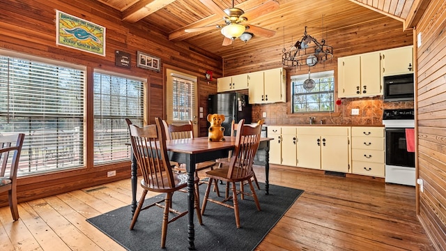 125 Brady Rd, Buena Vista, GA 31803 - dining area with lofted ceiling with beams, light wood-style flooring, wood ceiling, and wood walls