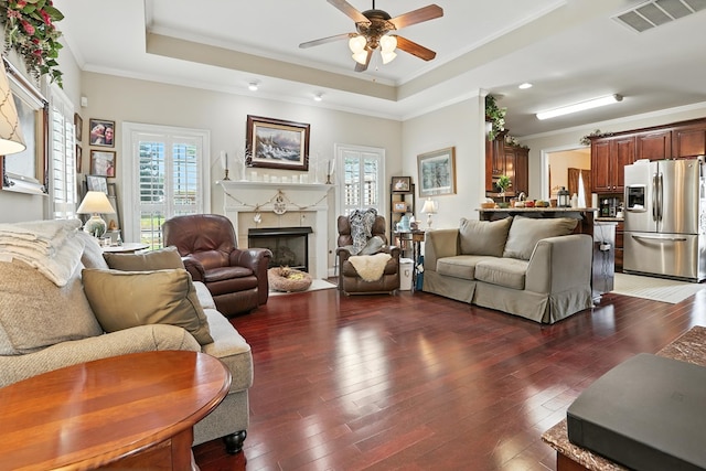 4256 Anglin Rd, Columbus, GA 31907 - living room featuring plenty of natural light, a tray ceiling, ornamental molding, a ceiling fan, and a tile fireplace