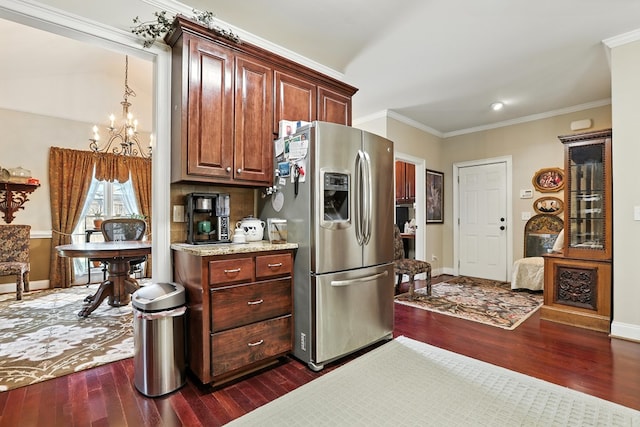 4256 Anglin Rd, Columbus, GA 31907 - kitchen featuring stainless steel refrigerator with ice dispenser, dark wood-style flooring, a chandelier, ornamental molding, and light stone counters