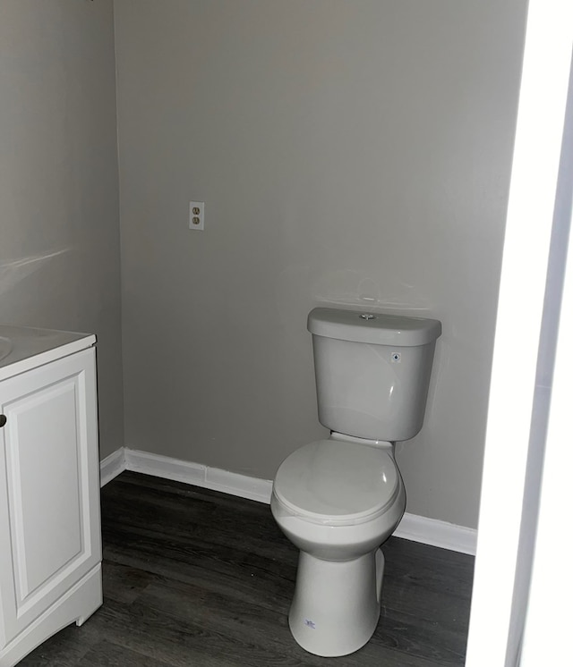 bathroom featuring toilet, vanity, and hardwood / wood-style flooring