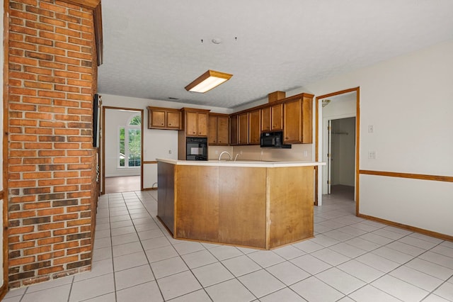 kitchen featuring light countertops, light tile patterned flooring, and black appliances